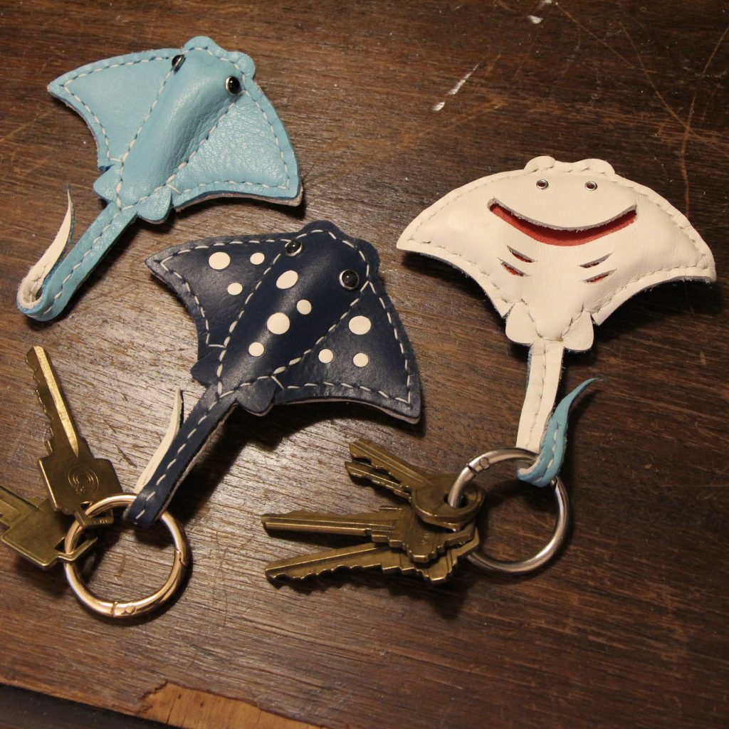 Three leather keychains shaped like stingrays