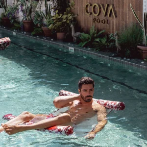 A man sits on a pool float