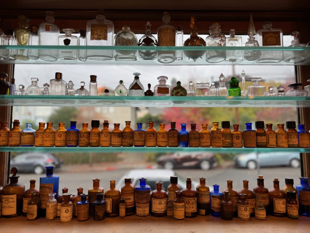 Glass shelves with vintage scent sample bottles