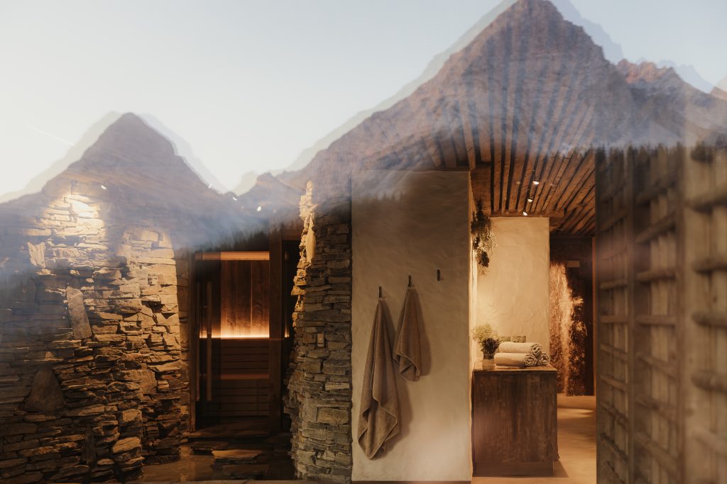 looking into the spa from outside with the mountains reflected in the window