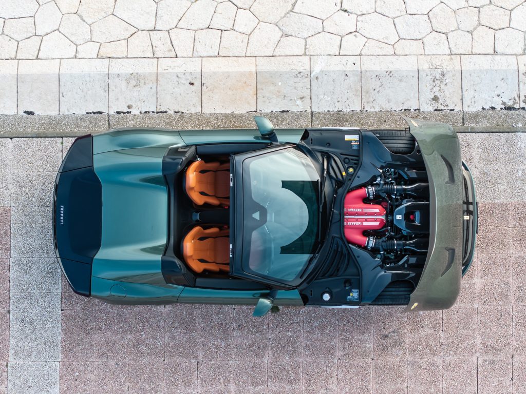 view of car from above with hood open to see engine