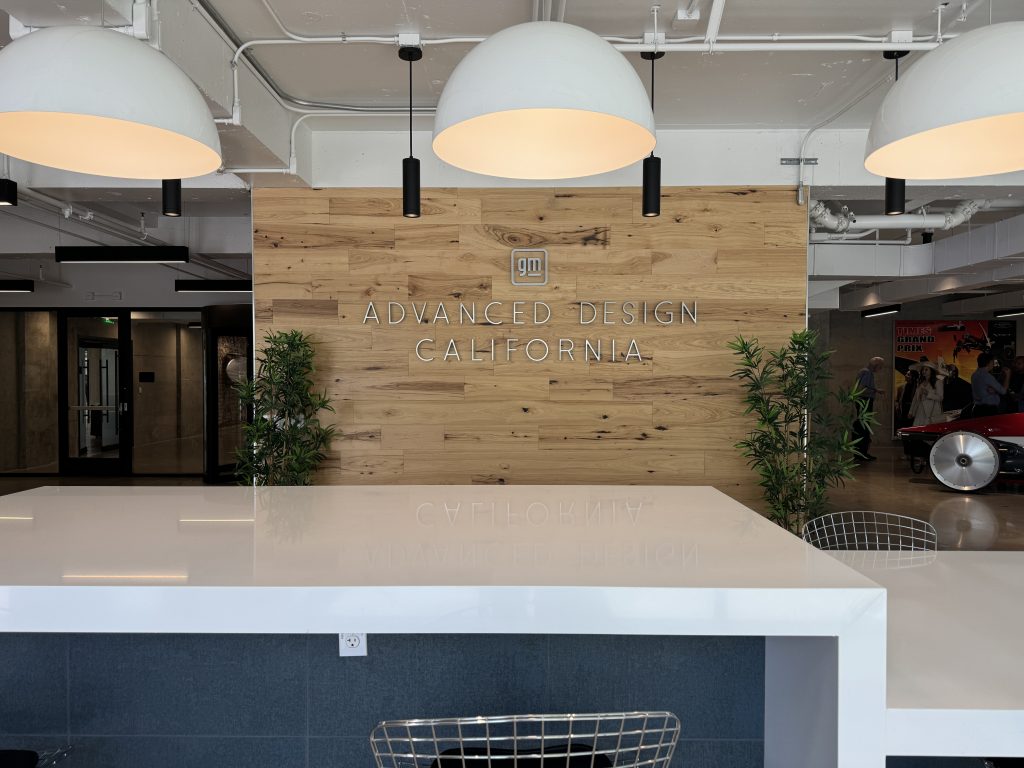 gm Advance Design Center sign on wood wall at entry to the building