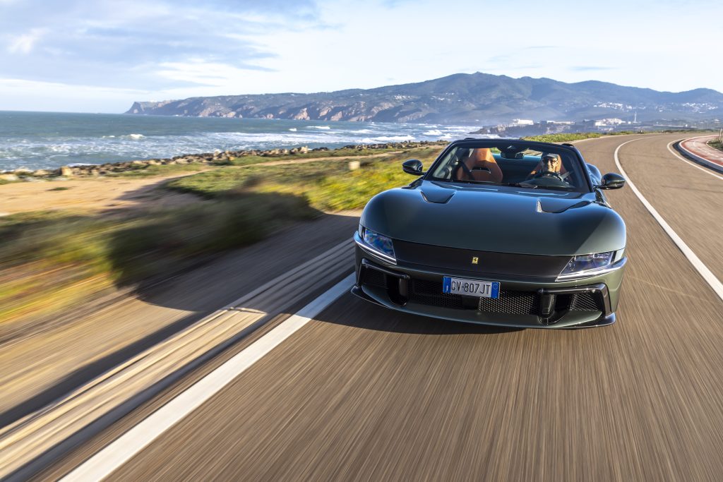 front view of car in motion with smiling driver