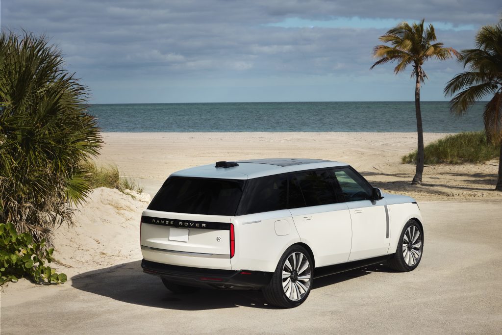 two-tone Range Rover on a beach