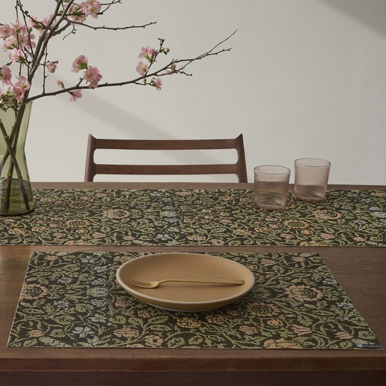 A Collection of Placemats, Runner and a Rug Featuring Textiles From The Met