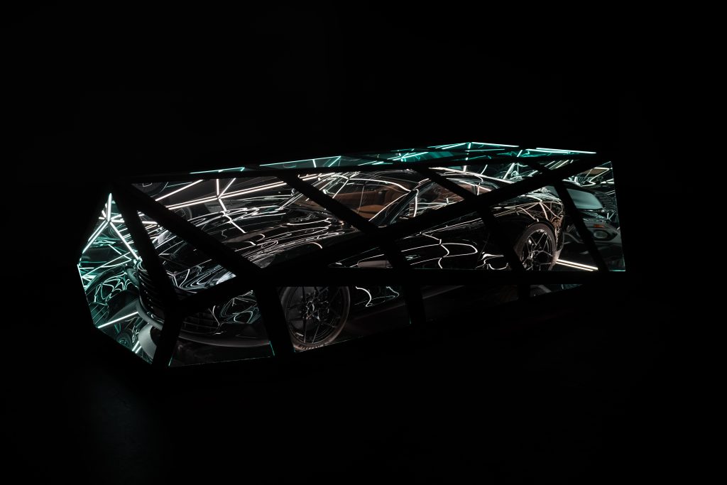 Artist Anthony James wrapped an Aston Martin Vanquish car in glass and metal box with lighting