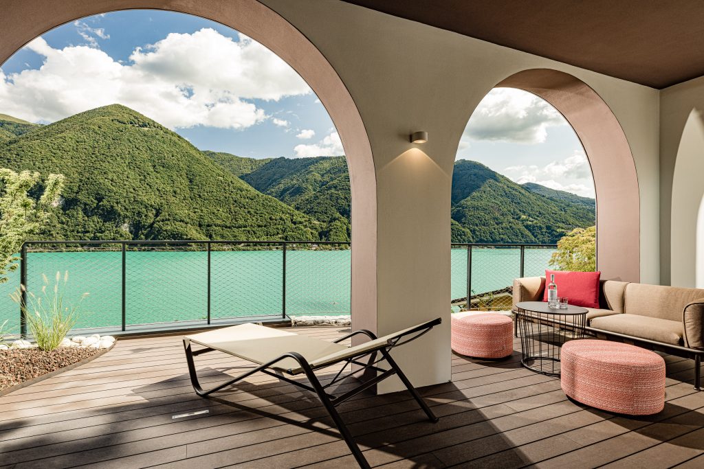 A view through a patio's archways from a room to the lake